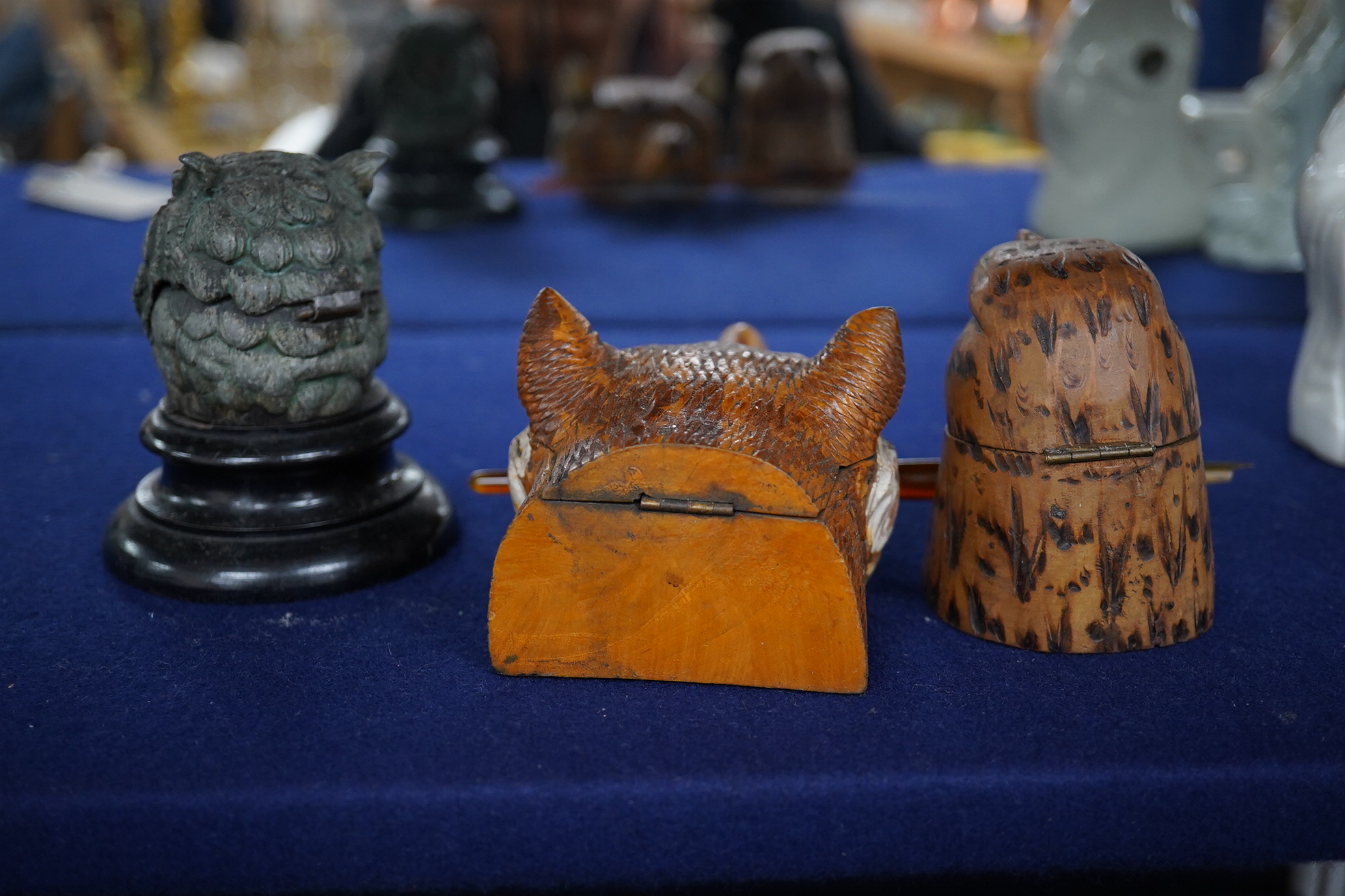 Two carved wood novelty inkwells in the form of animals, one with pen, together with a lead owl inkwell, largest 9cm high. Condition - fair